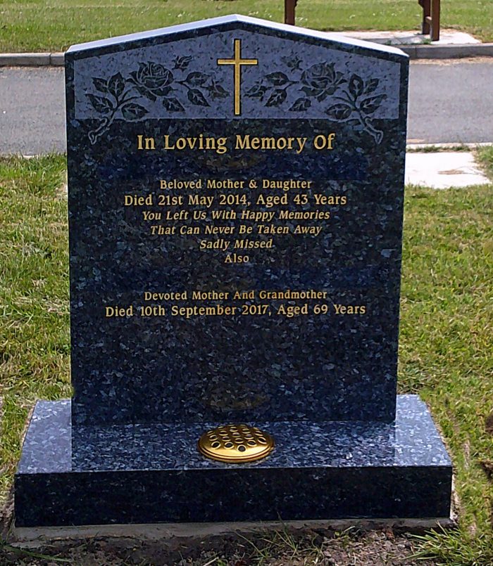 The Peon memorial headstone with blasted roses and gold cross hand painted